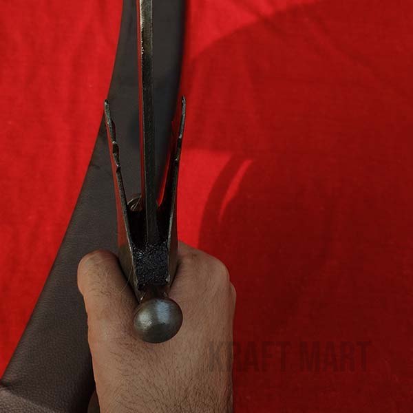 Close-up of the Tegha sword hilt showing intricate traditional design work