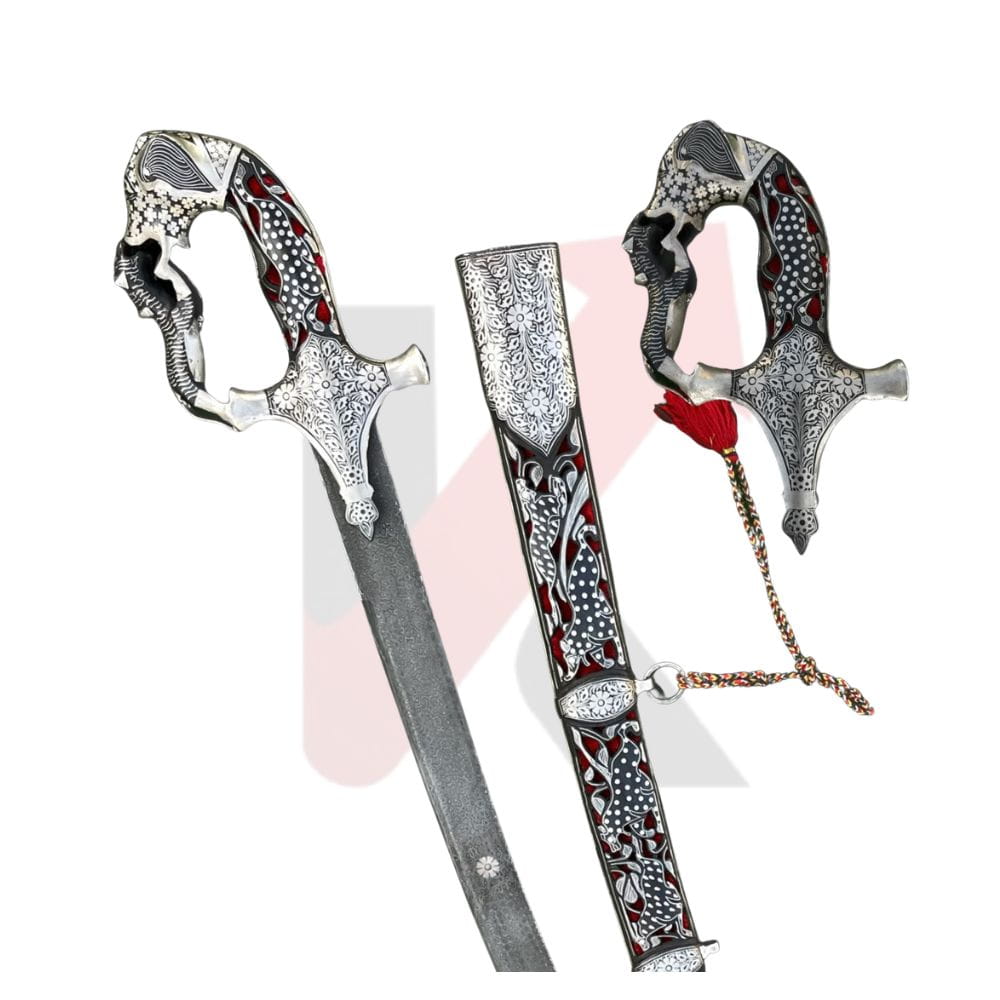 An ornate silver-colored ceremonial sword with intricate red and black floral engravings on the hilt and scabbard, displayed alongside its matching sheath on a white background. Imperial mughal shamshir by kraftmart 