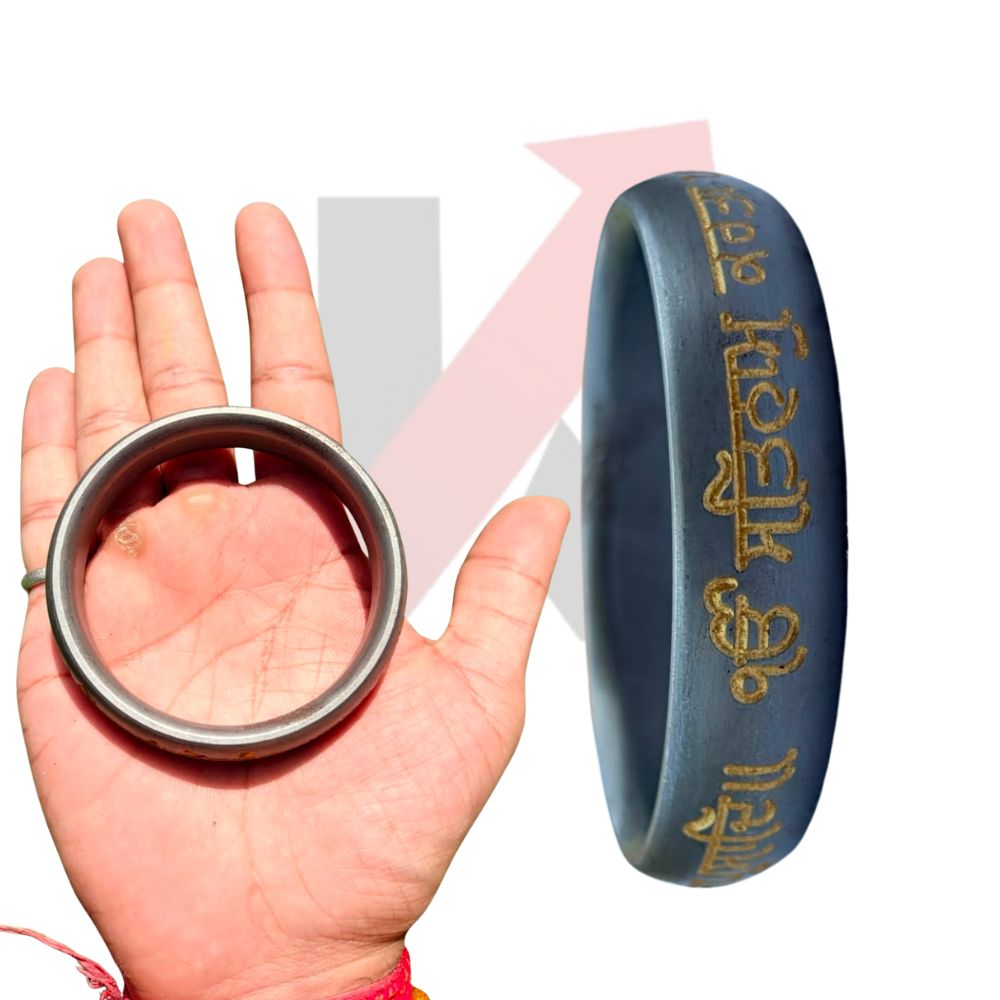 A dark blue-gray punjabi bracelet with gold script, shown alongside a hand holding a silver-toned ring for scale, on a white background with a kraftmart graphic 