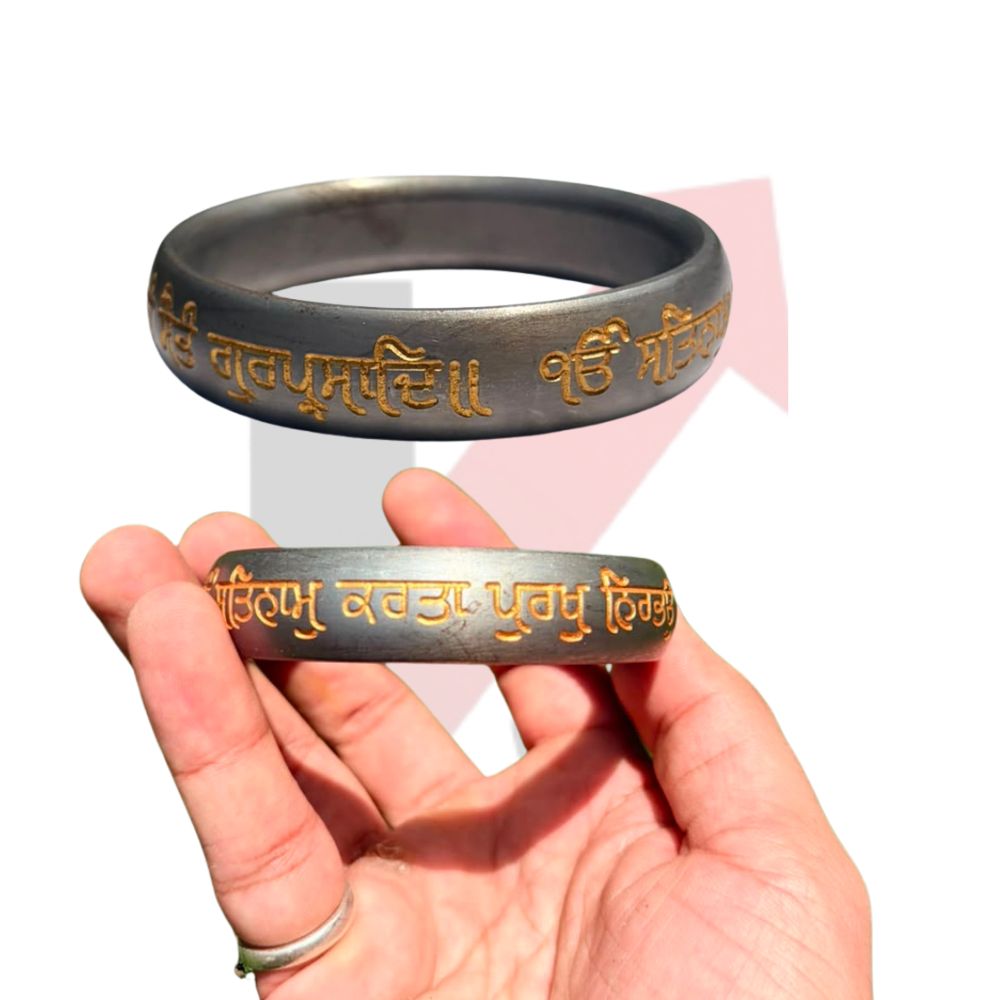 A hand holding a metallic silver-toned bracelet with gold-colored Tibetan script, with a larger, clearer view of the same bracelet floating above the hand against a white background with a faint kraftmart  graphic.